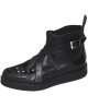 Black leather creeper with bovine fur, crossed strap and elastic side.